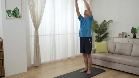 Male standing on exercise mat doing warmup Stock Footage 251095424