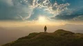 The male standing on the mountain against a sunny background 4k or 4k+ Resolution