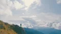 The male standing on a mountain cliff with the picturesque landscape 4k or 4k+ Resolution