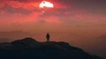 The male standing on the mountain top against the picturesque sunset. time lapse 4k or 4k+ Resolution