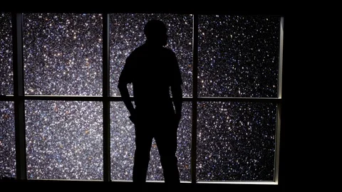 A male stands looking over an outer space scene in this futuristic concept. Stock Footage 112884179