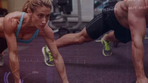 Male starting dumbbell row while female matching from plank on gym carpet, for Stock Footage 333670574