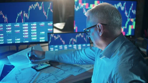 Male stockbroker is making notes is the data reports. Businessman trader, broker Video stock 168124318