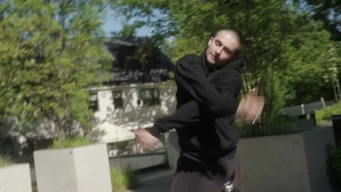 Male street dancer performs dynamic hip-hop style movements in an urban setting. Stock Footage 283489625