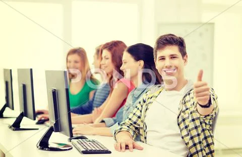 Male student with classmates in computer class Stock Photos