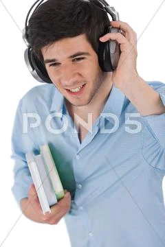 Male student with headphones holding books Stock Photos