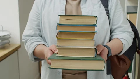 Male Student Holding Stack of Books for Academic Study Stock Footage 337474236