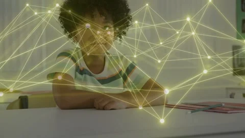 Male student looking at camera, initiating glowing web drifting over desk, 스톡 동영상 333632178