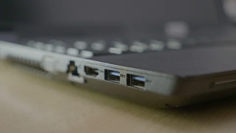 Male student plugging in an memory data stick into teachers usb laptop port t Video stock 87014236
