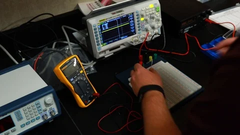 Male student at school testing electrical equipment in science class Stock Footage 123317930
