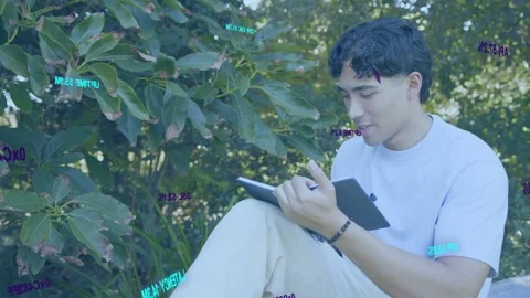 Male student sketching on tablet using stylus, causing data overlays over shrub Stock Footage 333911156