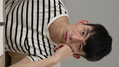 Male student staring at camera is propping head Stock Footage 209529081