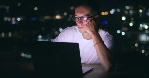 Male student studying online using laptop computer, sitting on roof workplace on Stock Footage 244192551