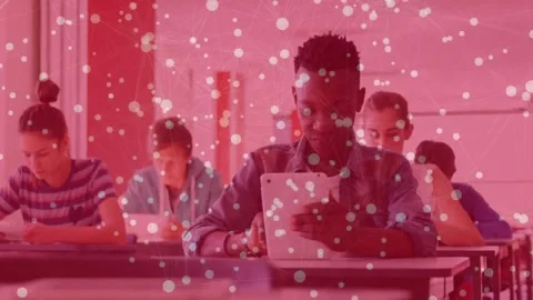 Male student tapping tablet for study in classroom as camera shifting to center Stock Footage 331227247