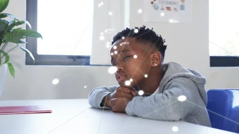 Male student tracking lights at white table in education, forming network Stock Footage 333911513