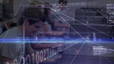 Male student typing in tech lab causing code overlay intensifying then receding Stock Footage 316185798