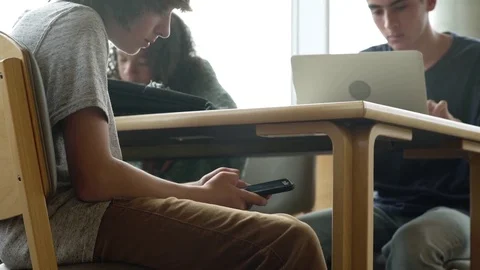 Male student using his smartphone during a class 動画素材 83398853