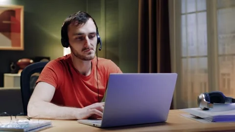 Male student wear headset e-learning studying with online tutor teacher talk Stock Footage 263130179