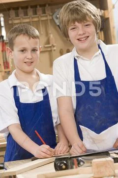 Male students reviewing woodworking plans Stock Photos