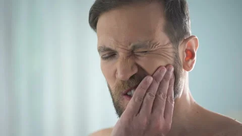Male suffering from tooth ache, strong dental pain, pulp inflammation, decay Stock Footage