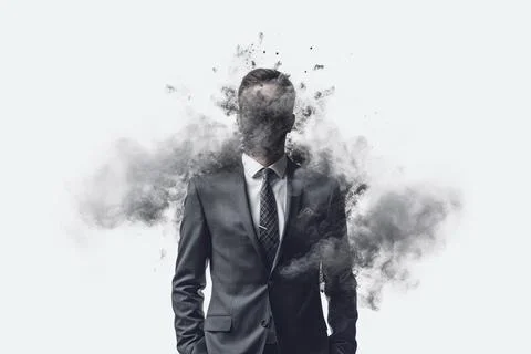 A male in a suit with a head in smoke exploding. Visualisation of the world of Stock Photos