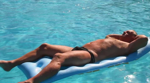 Male sunbathing on lilo Stock Footage 40704593