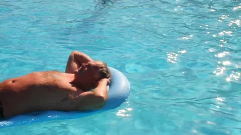 Male sunbathing on lilo Stock Footage 40704697