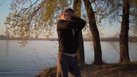 Male at Sunrise Practicing Kata Karate,honing His Skills,standing on the River Stock Footage