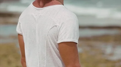 Male surfer on the beach, the wind develops your hair. Stock Footage 66578771