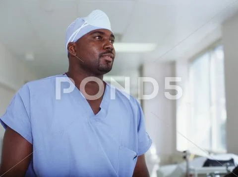Male surgeon in hospital hallway Stock Photos