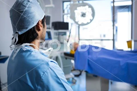 Male surgeon looking at unconscious patient Stock Photos