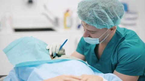Male surgeon performing delicate eye surgery in operating room Stock Footage 343629271