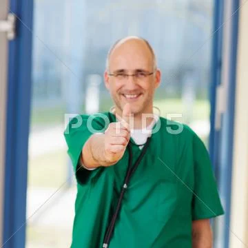 Male surgeon showing thumbs up sign Stock Photos