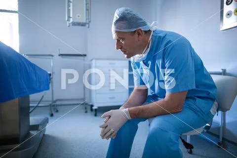 Male surgeon sitting on a chair Stock Photos