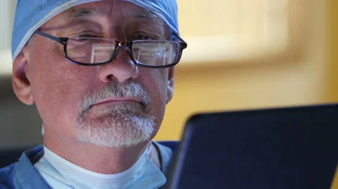 Male surgeon using ipad/tablet Stock Footage 54566981