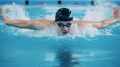 Male swimmer diving while crossing the pool in slow motion Stock Footage 151692178