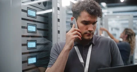 Male System Administrator Communicating Server Status by Mobile Phone Stock Footage 344959487