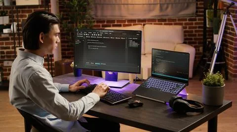 Male system hacker coding security program on pc software Stock Photos