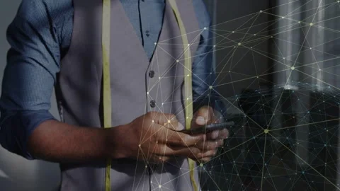 Male tailor tapping and scrolling phone, checking tape, network overlay shifting Stock Footage 333894278