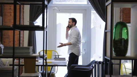 Male talking on telephone, discussing problems about documents Stock Footage 77607919