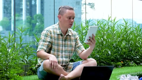 Male talks on tablet PC solving work problems and shows paper documents Stock Footage 137916444