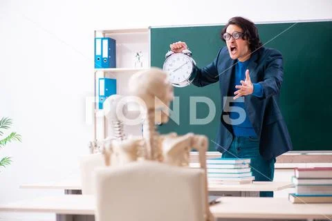 Male teacher and skeleton student in the classroom Stock Photos