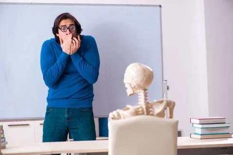 Male teacher and skeleton student in the classroom Stock Photos
