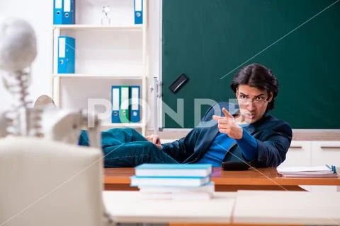 Male teacher and skeleton student in the classroom Stock Photos