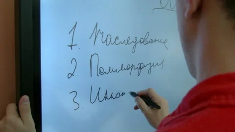 A male teacher drawing a graph using Interactive Projector Board, 21st century Stock Footage 85521558