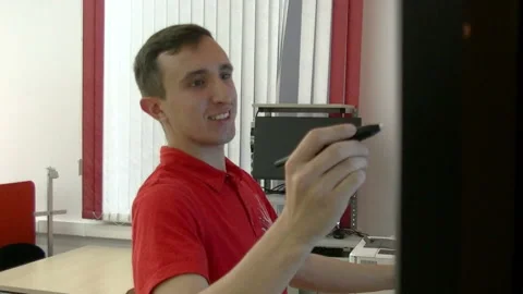 A male teacher drawing a graph using Interactive Projector Board, 21st century Stock Footage 85521714