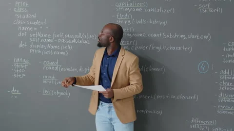 Male Teacher Explaining Code Description on Board Stock Footage 244694816