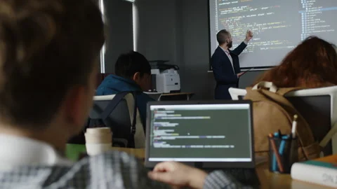 Male Teacher Explaining Coding Principles to Students at Programming Class Stock Footage 278124956