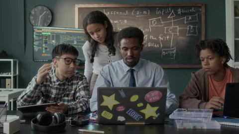 Male Teacher Explaining Software Engineering Topic to Group of Teen Students Stock Footage 284434178