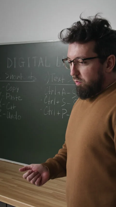 Male Teacher Pointing at Board in Computer Class Vertical Stock Footage 333707393